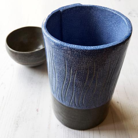 Tall blue and grey crackle glaze cylinder pot with decorative carving.