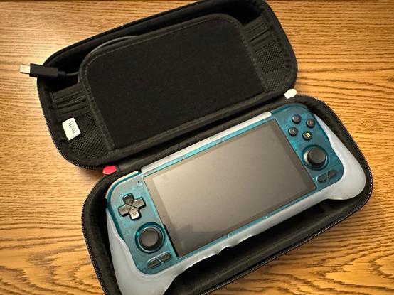 Ice Blue Retroid Pocket 4 Pro with official grip, in a Switch Lite case.