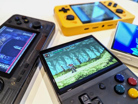 A collection of retro handhelds, including a Miyoo Mini, an RGB30 and a Retroid Pocket 2S