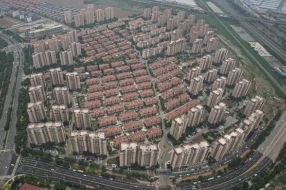 Rows and rows of partially inhabited high-rises sprawl into the suburbs of the northern Chinese metropolis of Tianjin, their empty balconies emblematic of a slowing economy that has not kept pace with the country's ambitions.