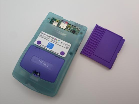 The back of the GBC showing the raspberry pi zero w 2 exposed where the cart normally sits. Also has L and R buttons sticking through the lable
