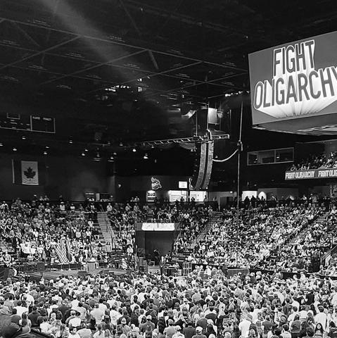 Big arena with "fight oligarchy" sign