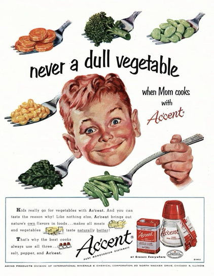 A young boy’s head looks possessed. His eyes are wide and he’s smiling. He seems very excited for multiple forks of vegetables. There’s corn, spinach, green beans and more.