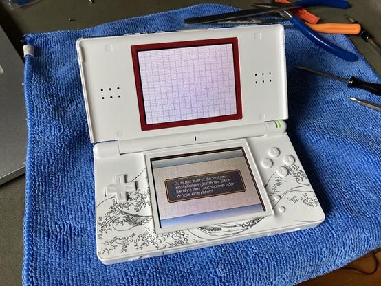 Finished DS lite showing the startup screens. The wave graphic is also printed on the lower case where the buttons and dpad are.