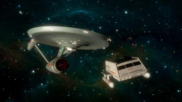 description by ChatGPT: This image is a detailed 3D render of two iconic spacecraft from the "Star Trek" universe, floating against a beautiful star-filled backdrop in deep space. On the left is the U.S.S. Enterprise, a large, disk-shaped starship with a saucer section at the top, connected to a cylindrical body with two long warp nacelles extending from the back. The ship’s surface is smooth and metallic, lit by numerous small white lights.

To the right is a much smaller shuttlecraft named “Galileo II.” It has a rectangular body with black windows in front and the words “U.S.S. Enterprise” written on the side in bold black letters. The shuttle also bears the registration number “NCC-1701/7.” Its hull is white, and it has two small cylindrical engines mounted underneath. Both vessels are set against a striking space backdrop, filled with stars and swirling nebulous clouds in shades of blue, green, and hints of gold, giving a sense of depth and cosmic scale. The image conveys a peaceful yet adventurous atmosphere, typical of classic science fiction.