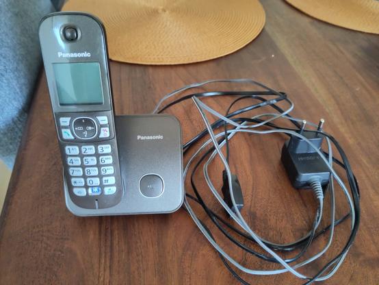 Das Telefon in der Ladeschale mit Netzteil und Anschlusskabel