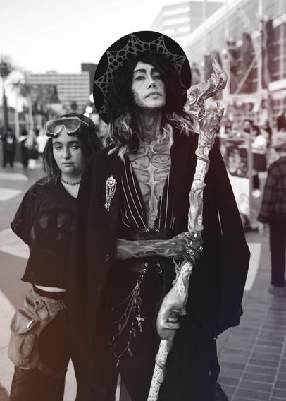 A young couple dressed in Arcane cosplay.  They are portraying Silco and Powder from the anime with appropriate makeup complementing the style used in the Netflix show.  This photo has been edited into black and white.