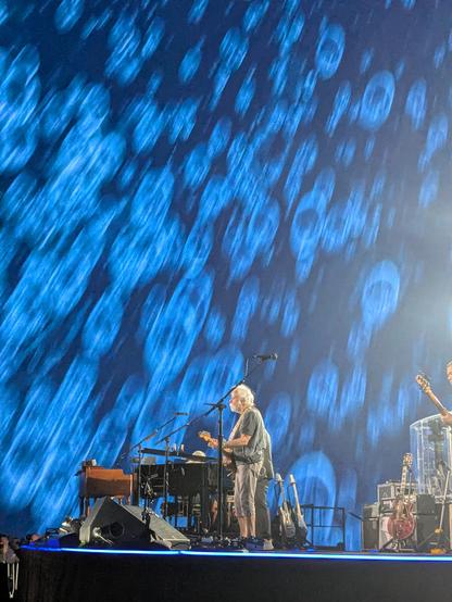 Bob Weir singing with a blue morphing background behind him