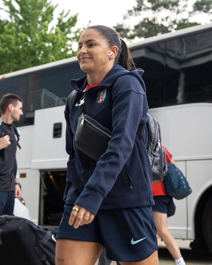 Debinha soft smiling as she arrives at the stadium