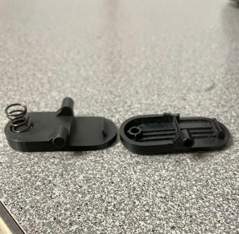 Picture showing new 3D printed part on the left and the old original part on the right. The old part has a broken off pivot point.