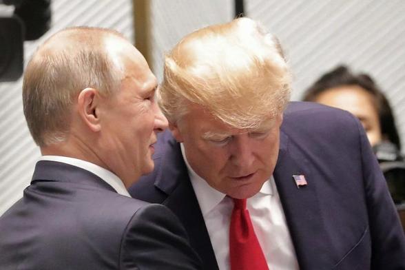 Photo of Trump and Putin. Putin seems to be telling something into Trump's ear.