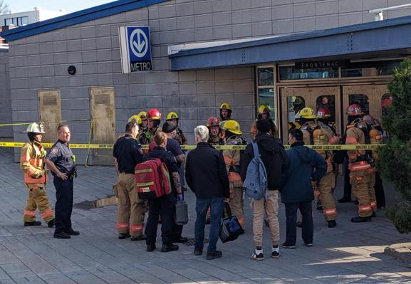 15-20 fire and rescue personnel in full outfits outside a metro station