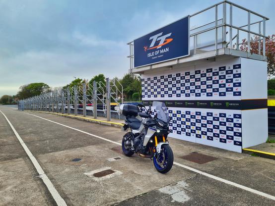 Tracer 9 parked in an empty TT pit lane in front of the podium