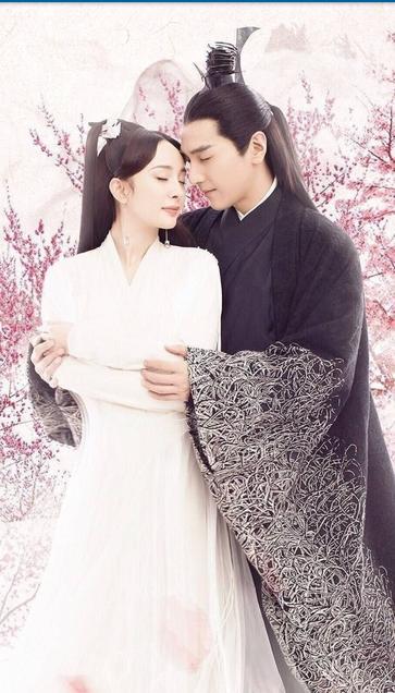 Color poster for Cdrama xianxia Eternal Love, Ten Miles Of Peach Blossoms showing our lead couple played by Yang Mi and Mark Chao in a loving embrace. Bai Qian is wearing a full length white dress and Ye Hua is wearing a black robe with intricate embroidery along the sweeping sleeves. The background is a grove of peach trees in blossom.