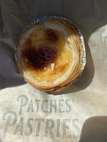 Closeup of my Portuguese tart on the paper bag with the Patches Patried logo.