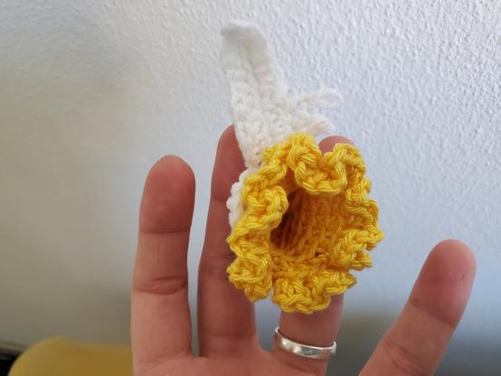 Crocheted yellow middle of daffodil  with on started white leaf