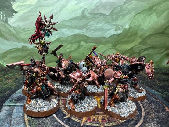 A group of chaos warriors on scree bases with nicely diverse skin tones waving swords etc, on scree bases
