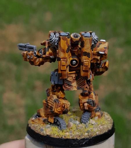 desert camouflage robot mech, covered in missiles and mortars, seen from behind.  metal model painted with acrylics