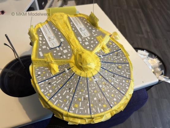Top of the saucer section with grey, blue and yellow masks applied to cover most of it.