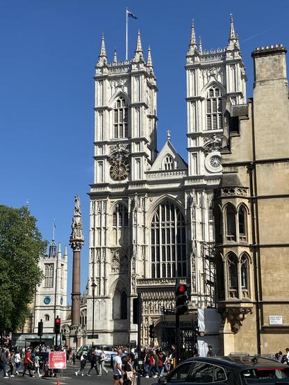 Westminster Abbey looking resplendent in the sunshine with a cloudless blue sky behind
