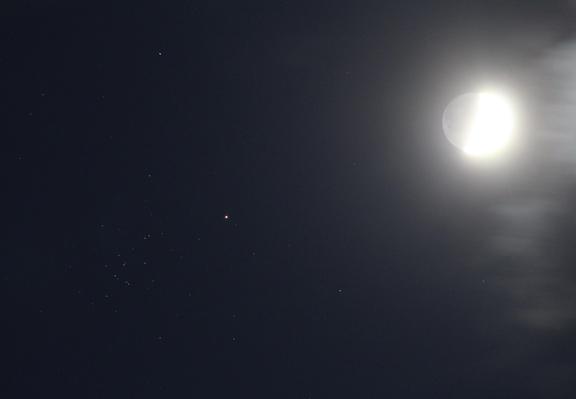 Very bright waxing crescent Moon next to right edge. Planet Mars left of centre. The Beehive cluster of stars to the left of Mars.