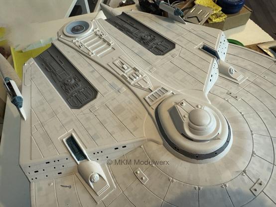 Top of the saucer showing two large areas painted dark grey