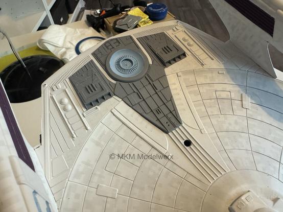 Bottom of the saucer section showing a large areas painted at the back painted dark grey.