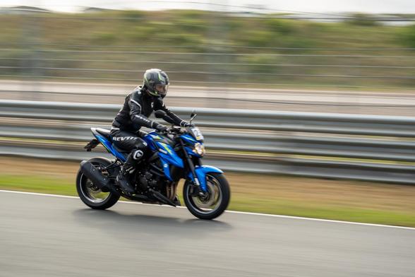 A blue motorcycle passing at high speed at Circuit Zandvoort.