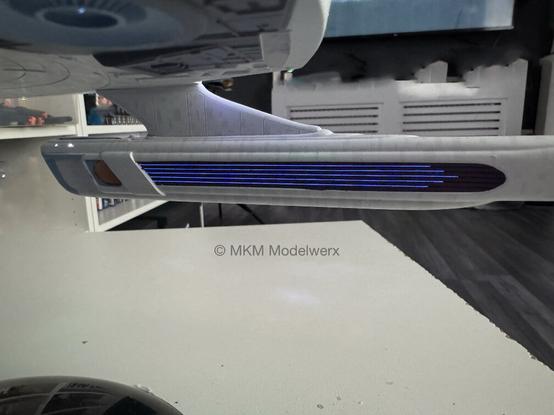 Inboard side of the starboard nacelle showing 5 blue lines lit up.