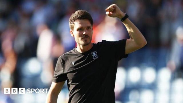 Sheffield Wednesday head coach Danny Rohl clenching his left fist in the air.