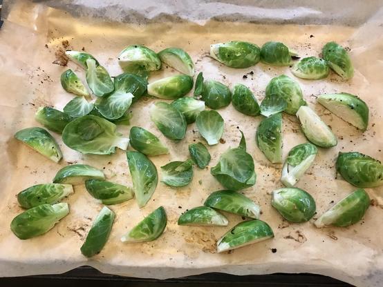 quartered brussels sprouts on a baking sheet lined with parchment paper