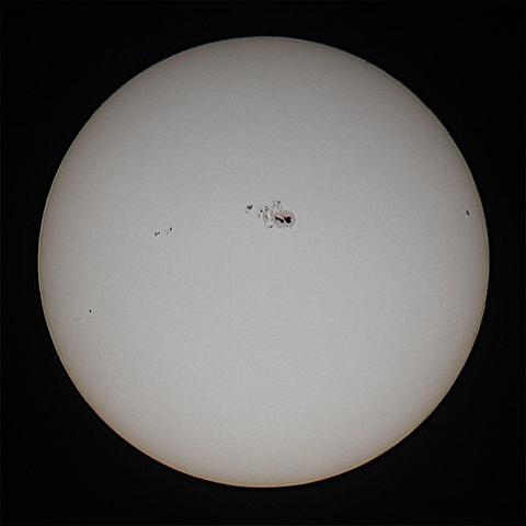 The Sun with spots including an enormous one at centre on a dark background.