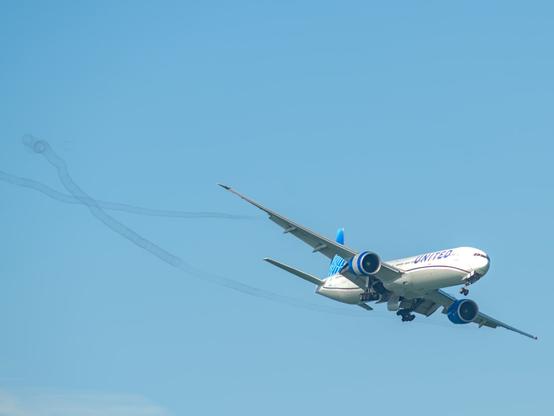 A Boeing 777 with smoke trails from the choreographed flight in San Francisco during the air show in 2024