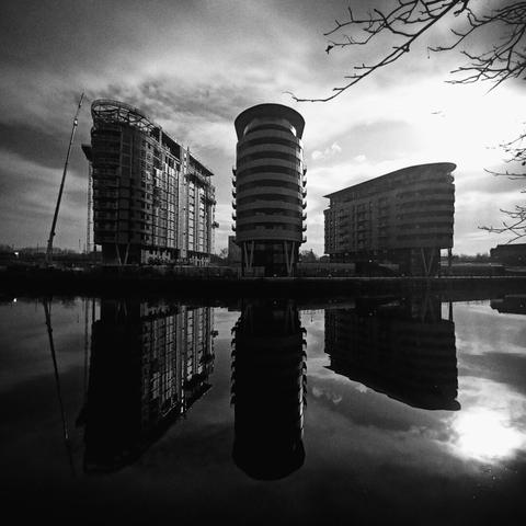 buildings reflected in a canal, wide angle