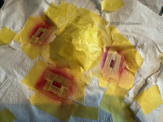 Yellow masks applied over small edges of the red