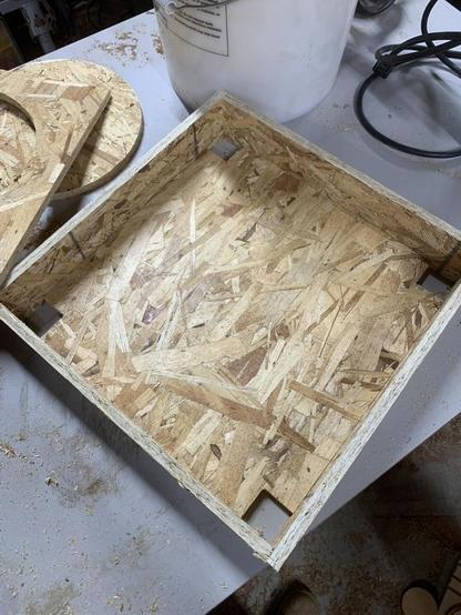 OSB bottom with notched corners being test fit inside the top frame