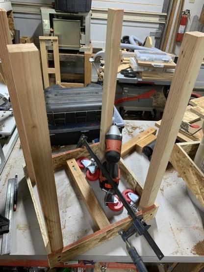 four posts screwed into the corners of the frame with the casters sitting on the bench, waiting to be screwed in