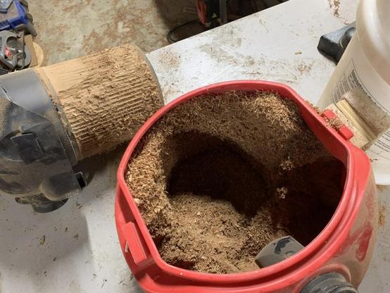 Inside the little shop-vac showing it’s packed full of sawdust