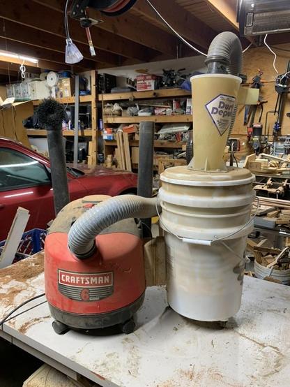 5 gallon bucket screwed to the side of a small 6 gallon Craftsman shop-vac with another bucket in the bucket and the cyclone on top