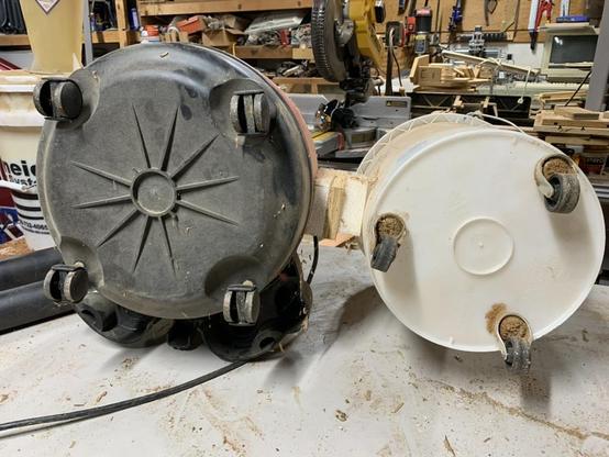 Shop-vac and bucket laying down to show how small the wheels are