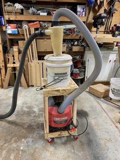 New cart sitting on the floor with the cyclone, the bucket, and the shop-vac all connected together