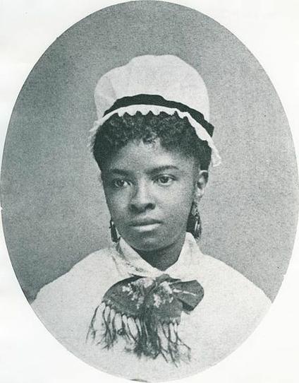 Mary Eliza Mahoney (April 16, 1845 – January 4, 1926), in a bonnet, with a bow around her neck. She was the first African American to study and work as a professionally trained nurse in the United States. By Unknown photographer - http://www.hcrhealth.com/content/our-community/blog/black-history-month-profile-mary-eliza-mahoney and as appears on the cover of Mary Eliza Mahoney, Public Domain, https://commons.wikimedia.org/w/index.php?curid=20285831
