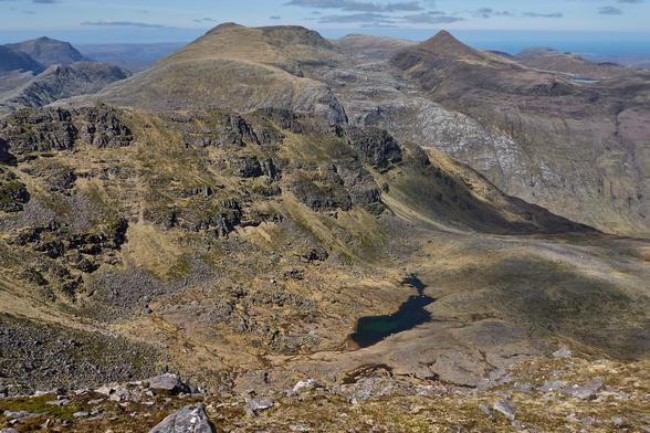 More rocky landscape looking to A' Mhaighdean and Ruadh Stac Mòr. To the left is Beinn Airigh Charr, with a glimpse of Poolewe in the middle.