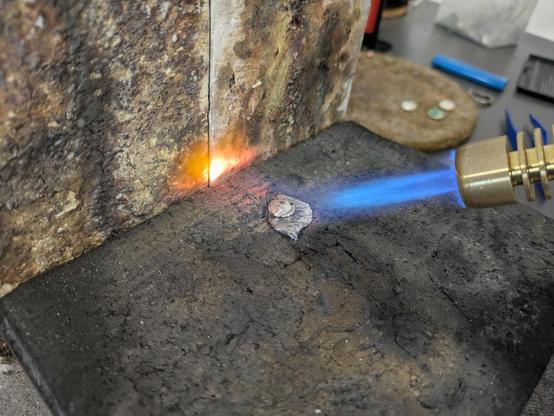 A few grammes of silver being heated by a blowtorch