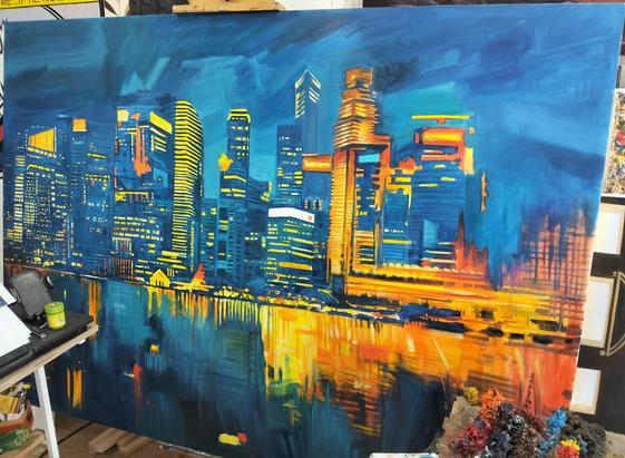 a large painting of city buildings at night next to a body of water