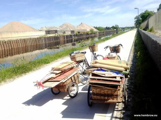 Two bicycles on a cycle-path in Assen. Both are pulling bicycle trailers full of old chipboard cupboards, carpets and other stuff destined for the dump. There was a date code on the back of one of the cupboards - it was an original kitchen cupboard from 1972, when our home was built.