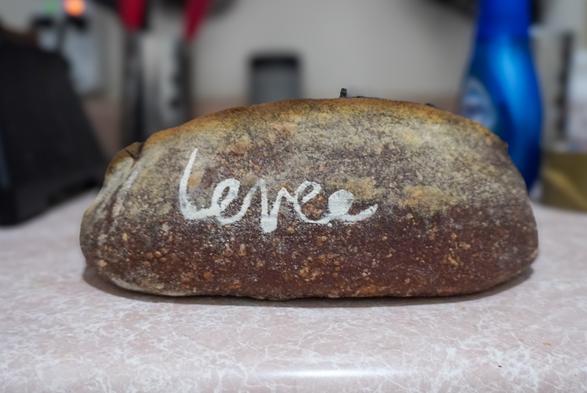 A loaf of black bread on a countertop.