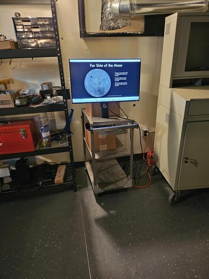 A science astronomy display screen on a cart next to a telescope equipment shelf at the York University Allan I Carswell Observatory 60cm dome