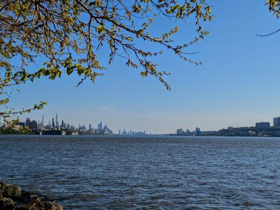 The river with the Manhattan and Jersey City skylines in the distant background.
