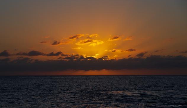A softly glowing sunset over the sea.